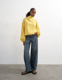 Model wearing Seam detail cuffed long sleeve top in yellow