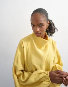 Model wearing Seam detail cuffed long sleeve top in yellow