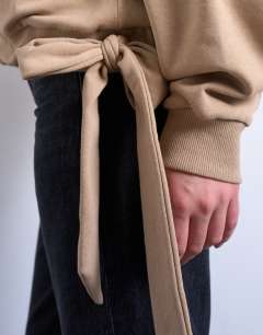 Model wearing Seam detail tie hem hoodie in tan