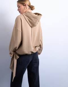 Model wearing Seam detail tie hem hoodie in tan