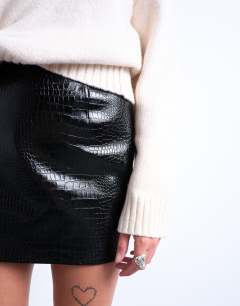 Model wearing Seamed detail faux leather mini in black