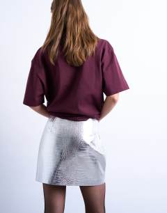Model wearing Seamed detail faux leather mini in metallic