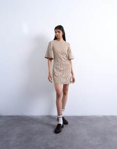 Model wearing Seersucker T-shirt mini dress in brown check