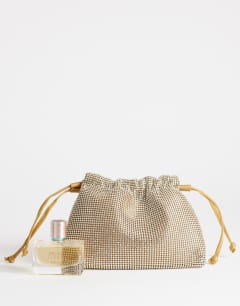 Model wearing Seleena small diamante drawstring clutch bag in gold