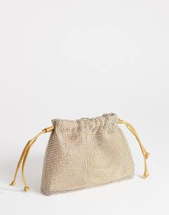 Model wearing Seleena small diamante drawstring clutch bag in gold