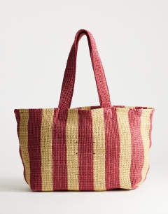 Model wearing Selia large stripe straw tote bag in red & pink