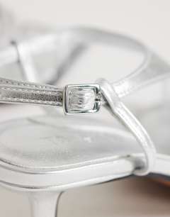 Model wearing Selina tie up heeled sandal with toe loop in silver