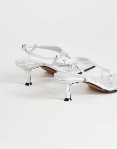 Model wearing Selina tie up heeled sandal with toe loop in silver