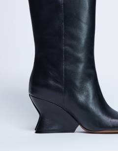 Model wearing Selma Premium leather knee high wedge boot in black