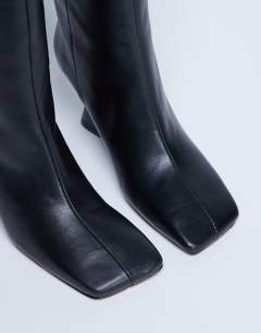 Model wearing Selma Premium leather knee high wedge boot in black