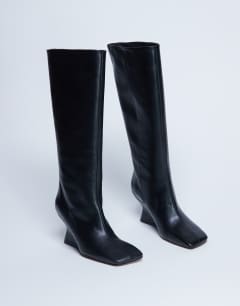 Model wearing Selma Premium leather knee high wedge boot in black