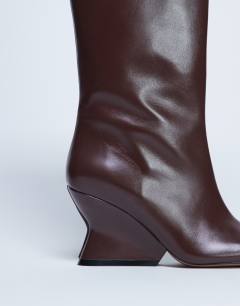 Model wearing Selma Premium leather knee high wedge boot in chocolate