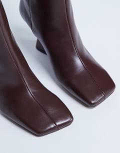 Model wearing Selma Premium leather knee high wedge boot in chocolate