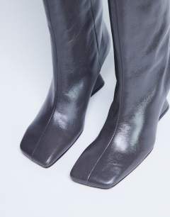 Model wearing Selma Premium leather knee high wedge boot in grey