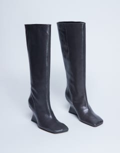 Model wearing Selma Premium leather knee high wedge boot in grey