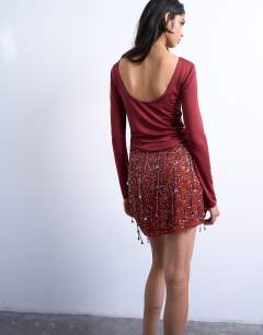 Model wearing Sequin mini skirt in burgundy