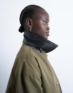 Model wearing Shacket with patch pocket in dark green