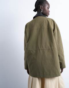 Model wearing Shacket with patch pocket in dark green