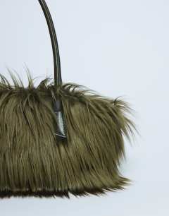 Model wearing Shaggy faux fur shoulder bag in khaki