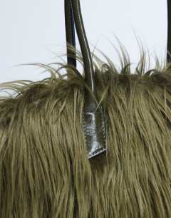 Model wearing Shaggy faux fur shoulder bag in khaki