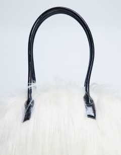 Model wearing Shaggy faux fur shoulder bag in off white