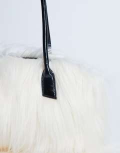 Model wearing Shaggy faux fur shoulder bag in off white
