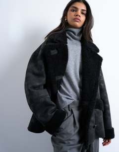 Model wearing Shearling oversized car coat in black