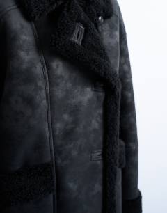 Model wearing Shearling oversized car coat in black