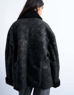 Model wearing Shearling oversized car coat in black