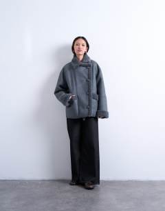 Model wearing Shearling oversized car coat in grey