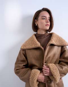 Model wearing Shearling oversized patch pocket mid length car coat in caramel