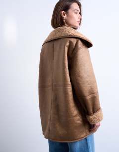 Model wearing Shearling oversized patch pocket mid length car coat in caramel