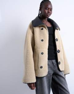 Shearling oversized reversible coat with button loop in black and cream
