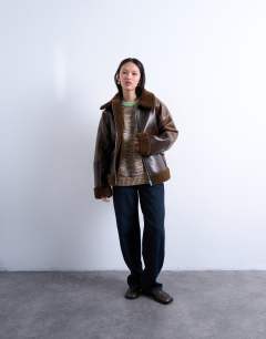 Model wearing Shearling patchwork faux leather jacket in brown