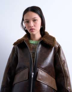 Model wearing Shearling patchwork faux leather jacket in brown