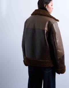 Model wearing Shearling patchwork faux leather jacket in brown