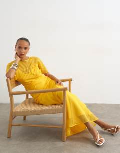 Model wearing Sheer chiffon maxi dress with pintuck details in Marigold