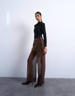 Model wearing Sheer double layer mock skirt trouser in brown