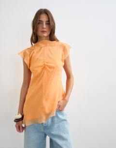 Model wearing Sheer drape neck top in rust