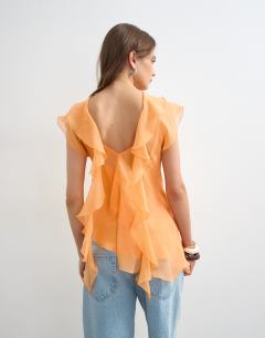 Model wearing Sheer drape neck top in rust