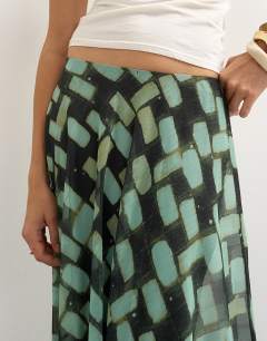 Model wearing Sheer full circle chiffon maxi skirt in blue geometric print