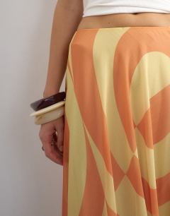 Model wearing Sheer full circle chiffon midi skirt in orange abstract print