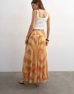 Model wearing Sheer full circle chiffon midi skirt in orange abstract print