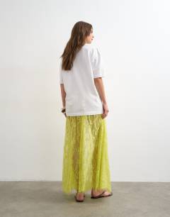 Model wearing Sheer lace maxi skirt in lime green