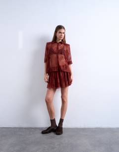 Model wearing Sheer lace shirt in rust