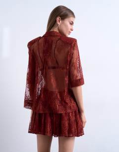 Model wearing Sheer lace shirt in rust