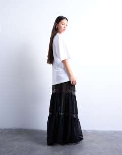 Model wearing Sheer maxi with lace inserts in black