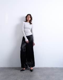 Model wearing Sheer metallic long sleeve top in silver