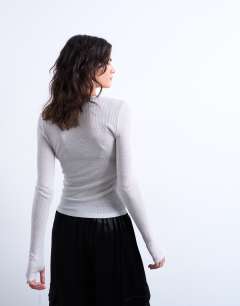 Model wearing Sheer metallic long sleeve top in silver