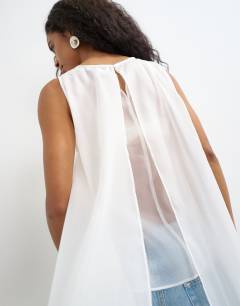 Model wearing Sheer organza drape tunic top in white